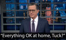 A man in a suit stands on a talk show stage looking confused. The quote at the bottom reads, "Everything OK at home, Tuck?"