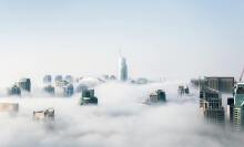the new york city skyline shrouded in clouds