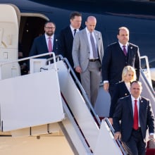 Elon Musk and members of Donald Trump's team walk out of a private plane.