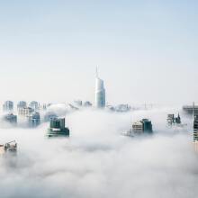 the new york city skyline shrouded in clouds